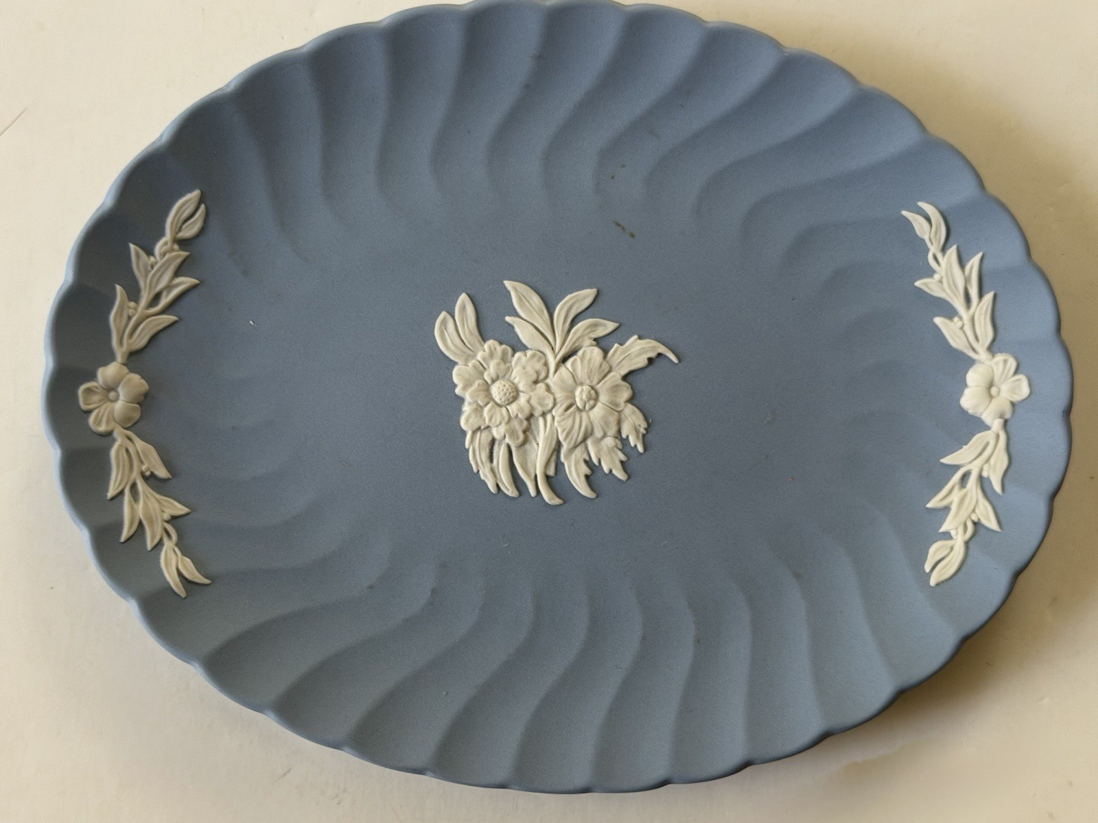 Small Wedgwood Jasperware plate, 7 X 5” oval, floral, matte blue, raised white Small Wedgwood Jasperware plate, 7 X 5” oval, floral, matte blue, raised white