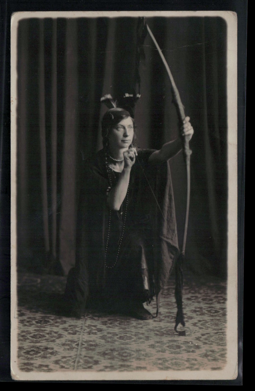 RPPC Postcard Girl in Indian Feather Headress and Moccassins Posing with Bow