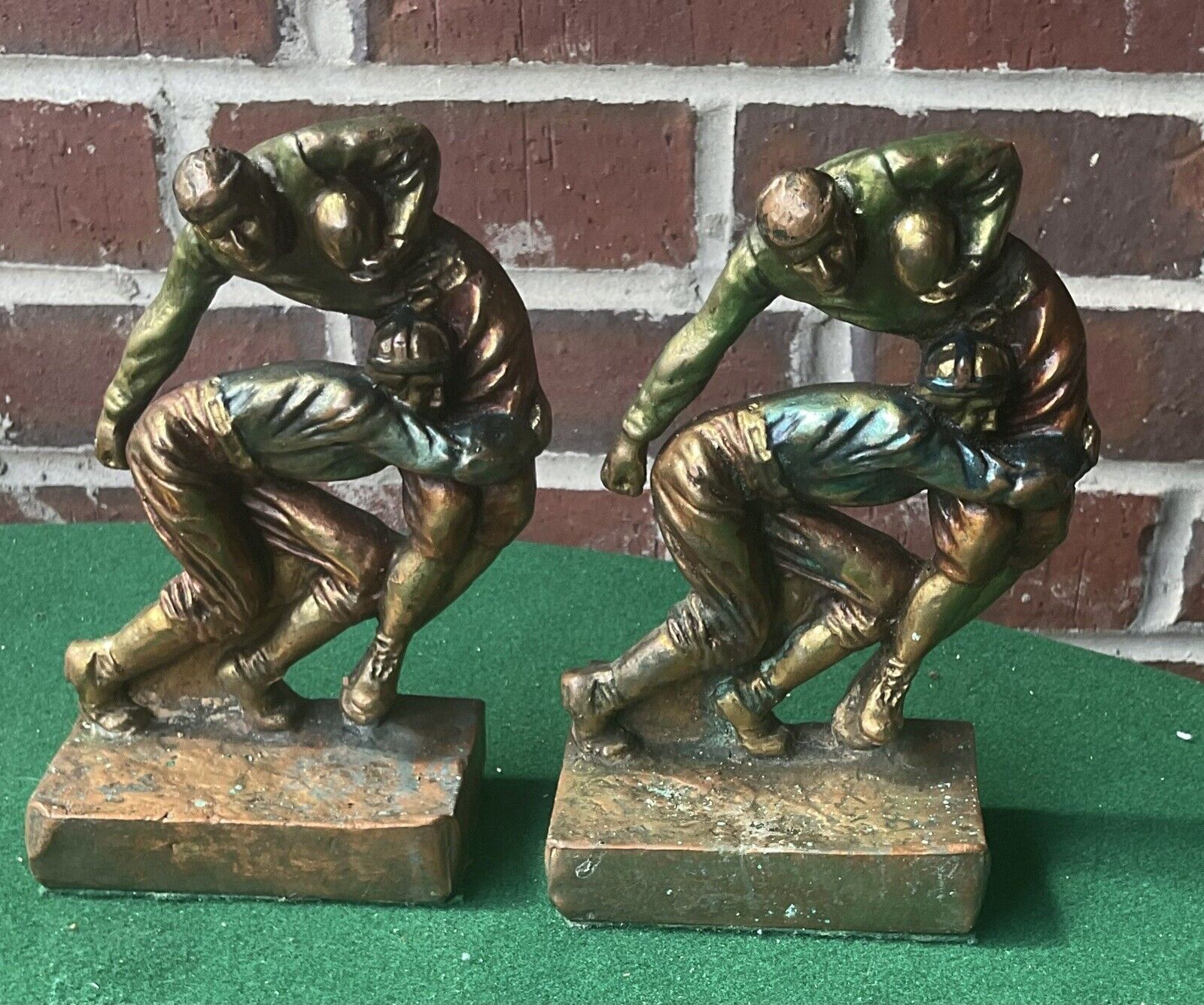 antique Pompeian Bronze bookends, football leather helmets, painted, c. 1925