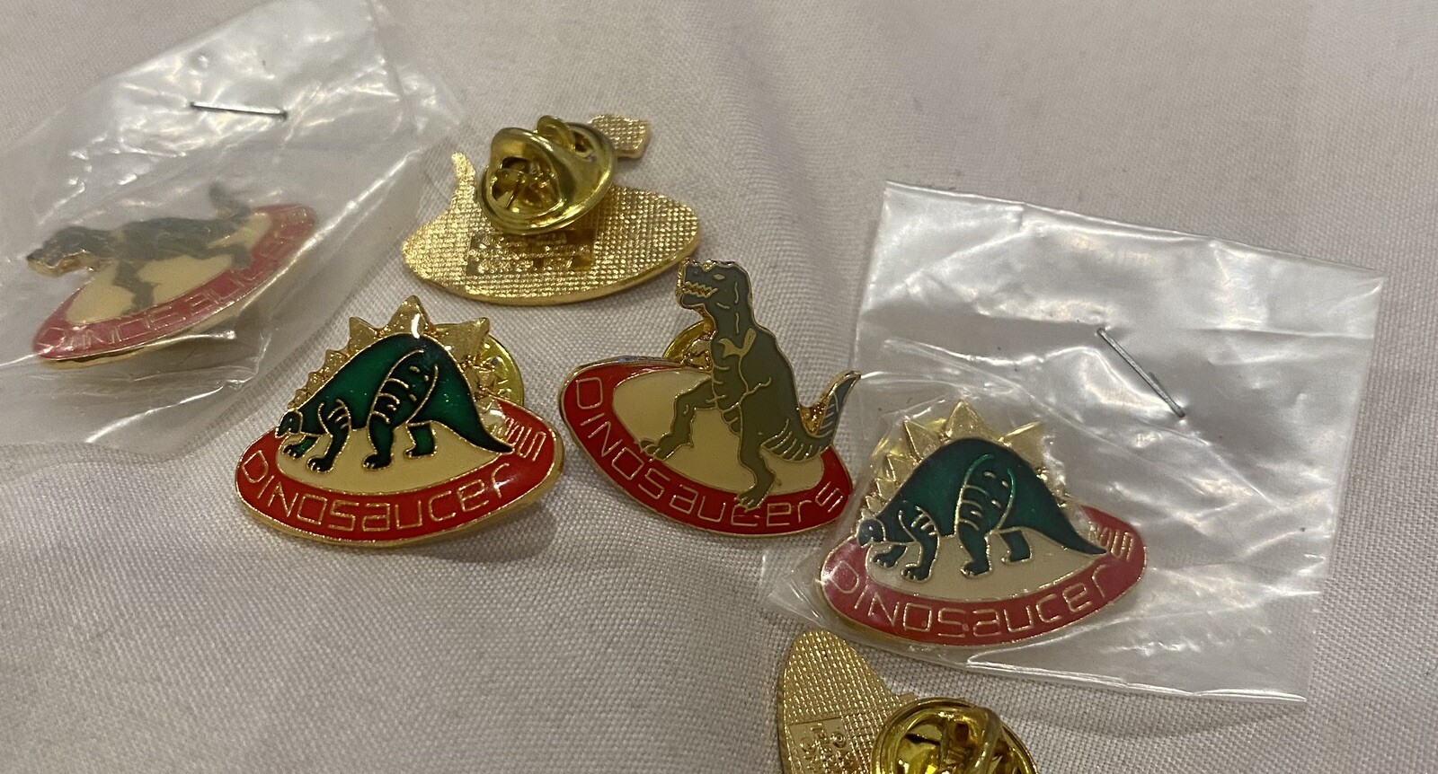 Vintage 1987 Dinosaucer Lapel Pin. Coca Cola Telecommunications 1987 Printed on