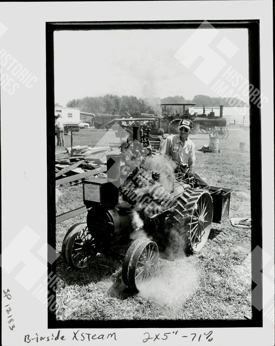 1982 A man sitting on a steam tractor