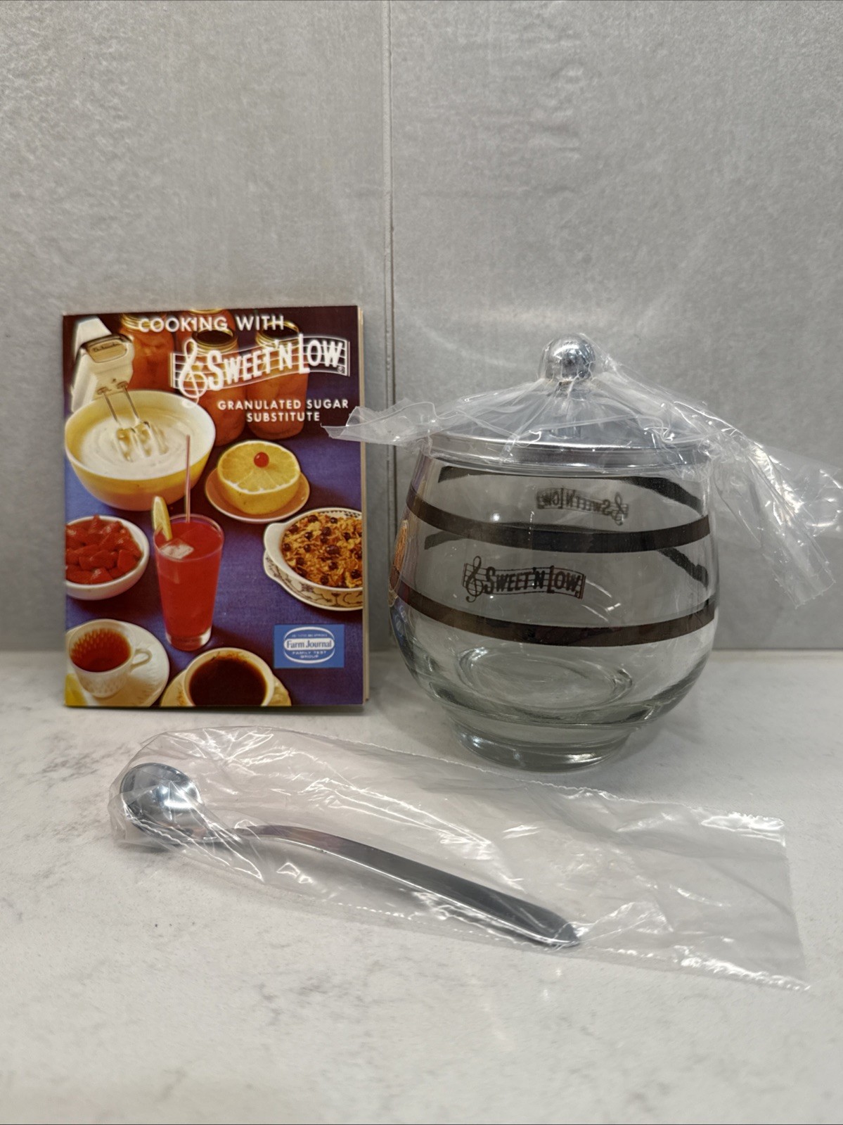 1965 Sweet ‘N Low Glass Container with Spoon and Cookbook BRAND NEW