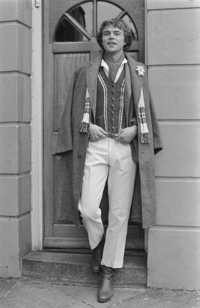 Male model wearing white trousers and a long tweed coat UK 1970s OLD PHOTO