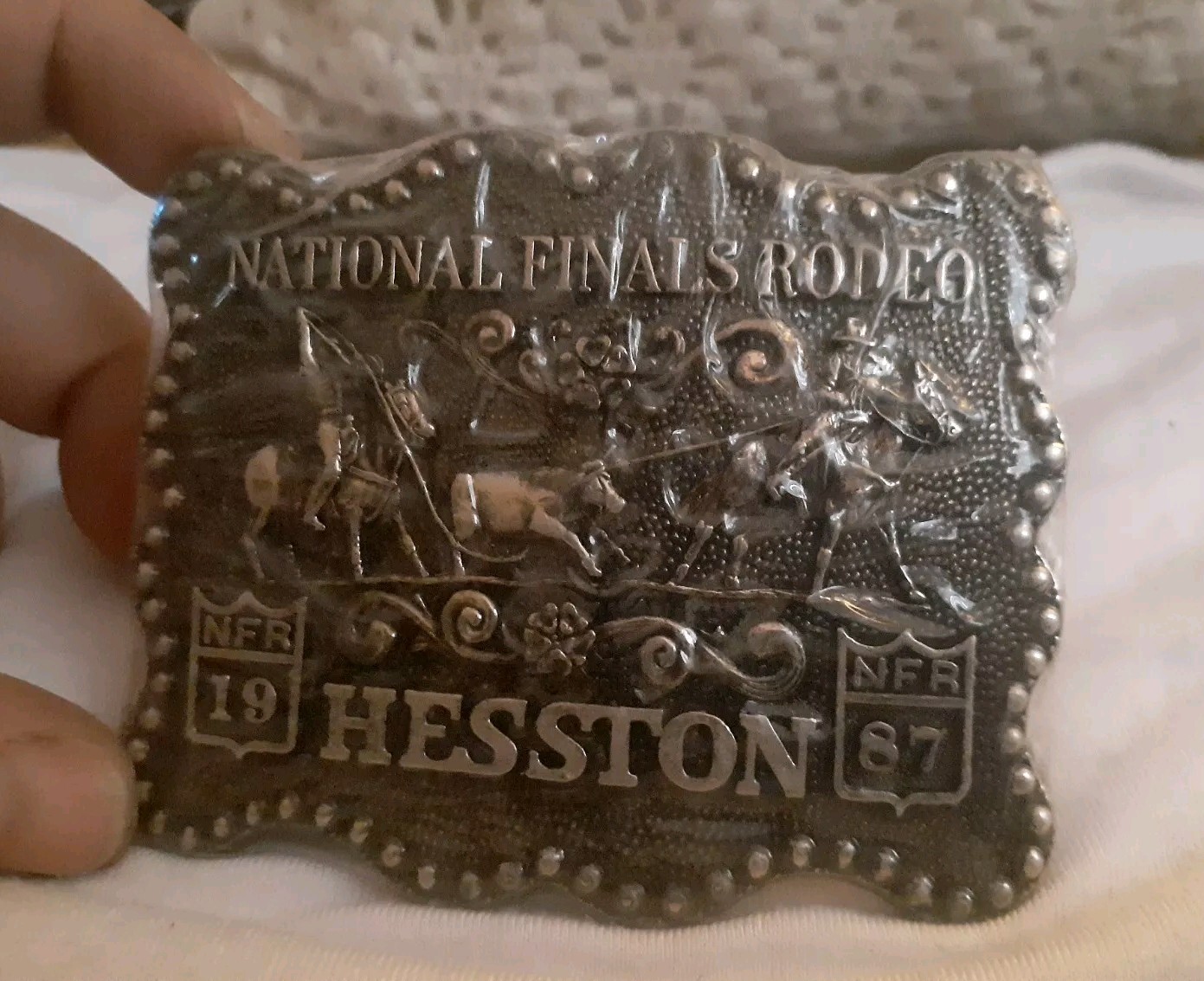 Vintage Hesston new National Finals Rodeo belt buckle. Gold tone. sealed Vintage Hesston new National Finals Rodeo belt buckle. Gold tone. sealed