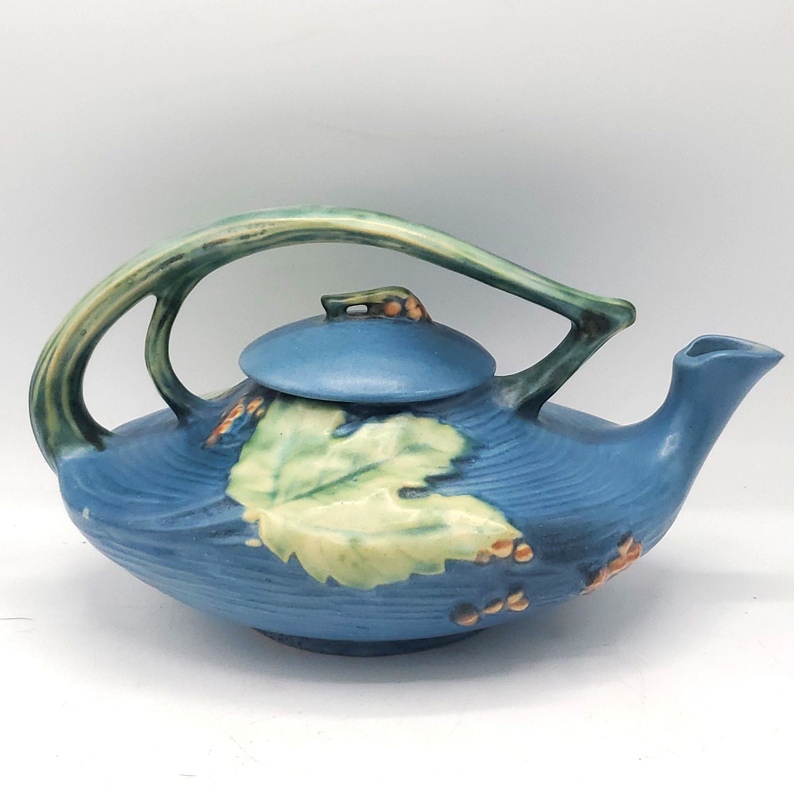Vintage Roseville Pottery Bushberry Teapot 2-T Blue background