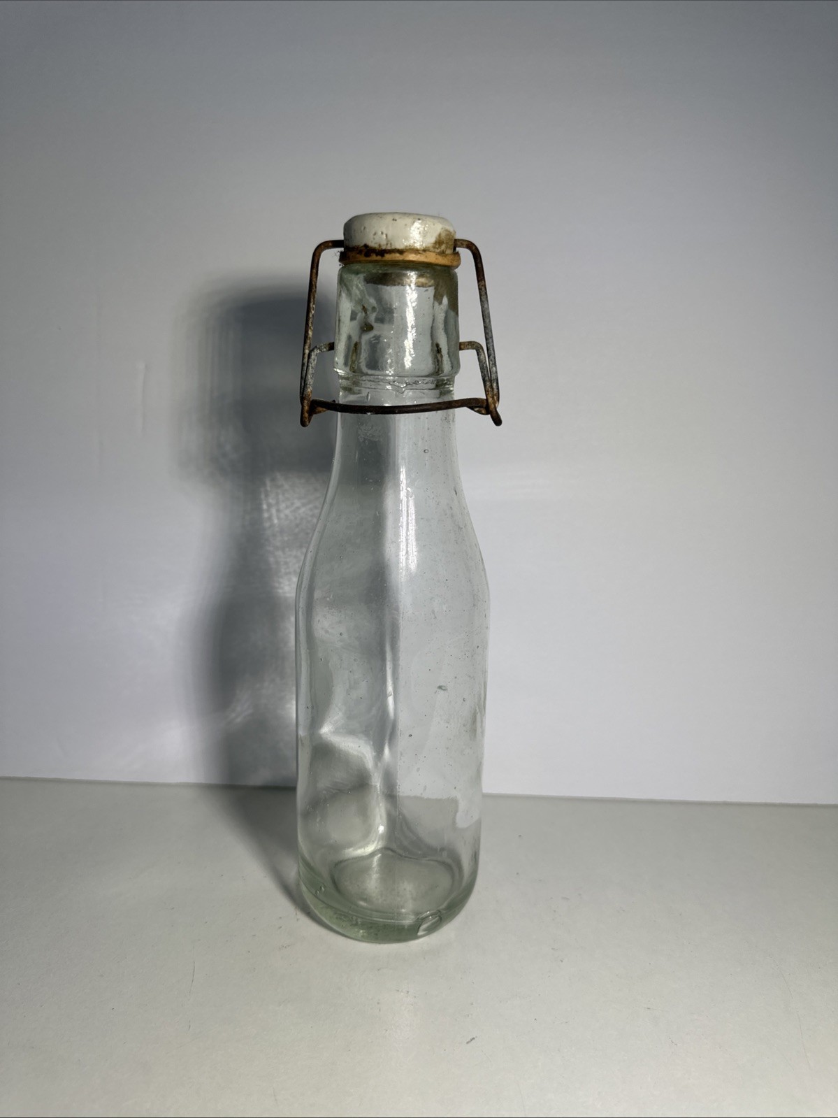 VTG Clear Bottle with Wire and Porcelain Top, 20” Tall VTG Clear Bottle with Wire and Porcelain Top, 20” Tall