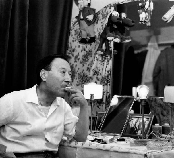 Italian actor comedian Erminio Macario smoking a cigarette seated - Old Photo