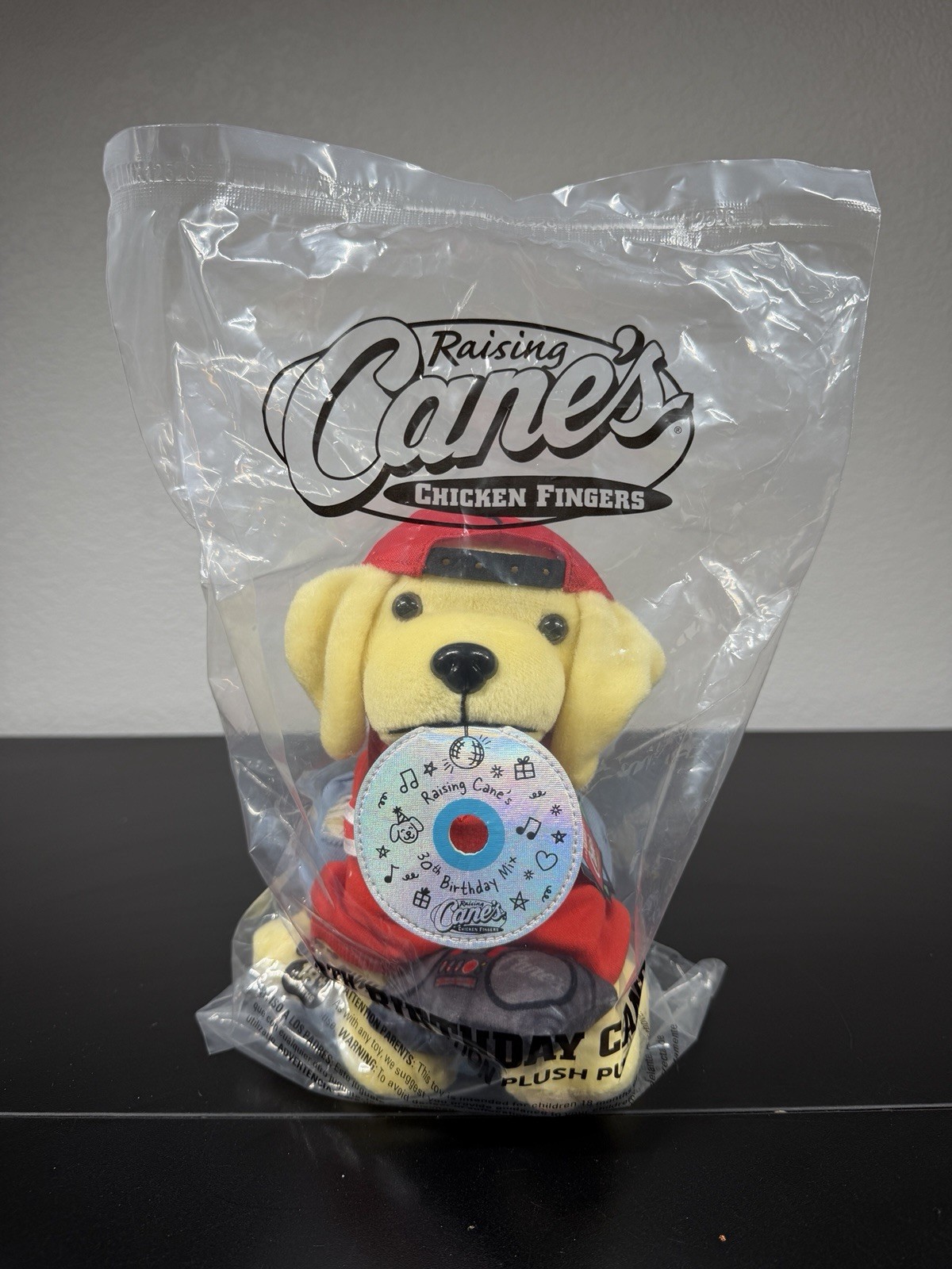 NEW Limited Edition Raising Cane's 30th Birthday Plush Dog w/ Cap, CD & Boombox NEW Limited Edition Raising Cane's 30th Birthday Plush Dog w/ Cap, CD & Boombox