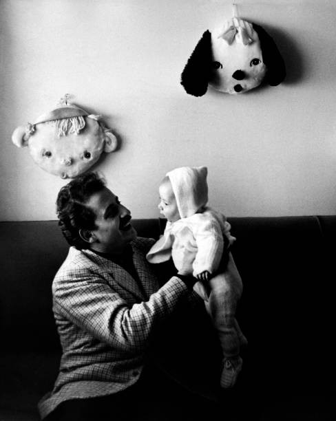 The Italian singer actor Domenico Modugno holding son Marco arms 1- Old Photo