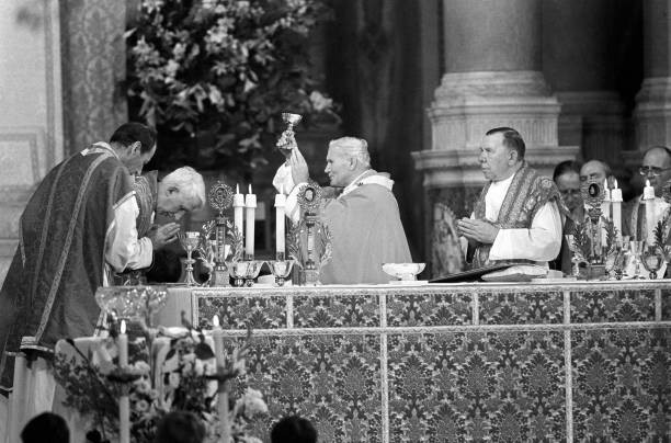 Pope John Paul II raises chalice company of praying Cardinal Basil- Old Photo