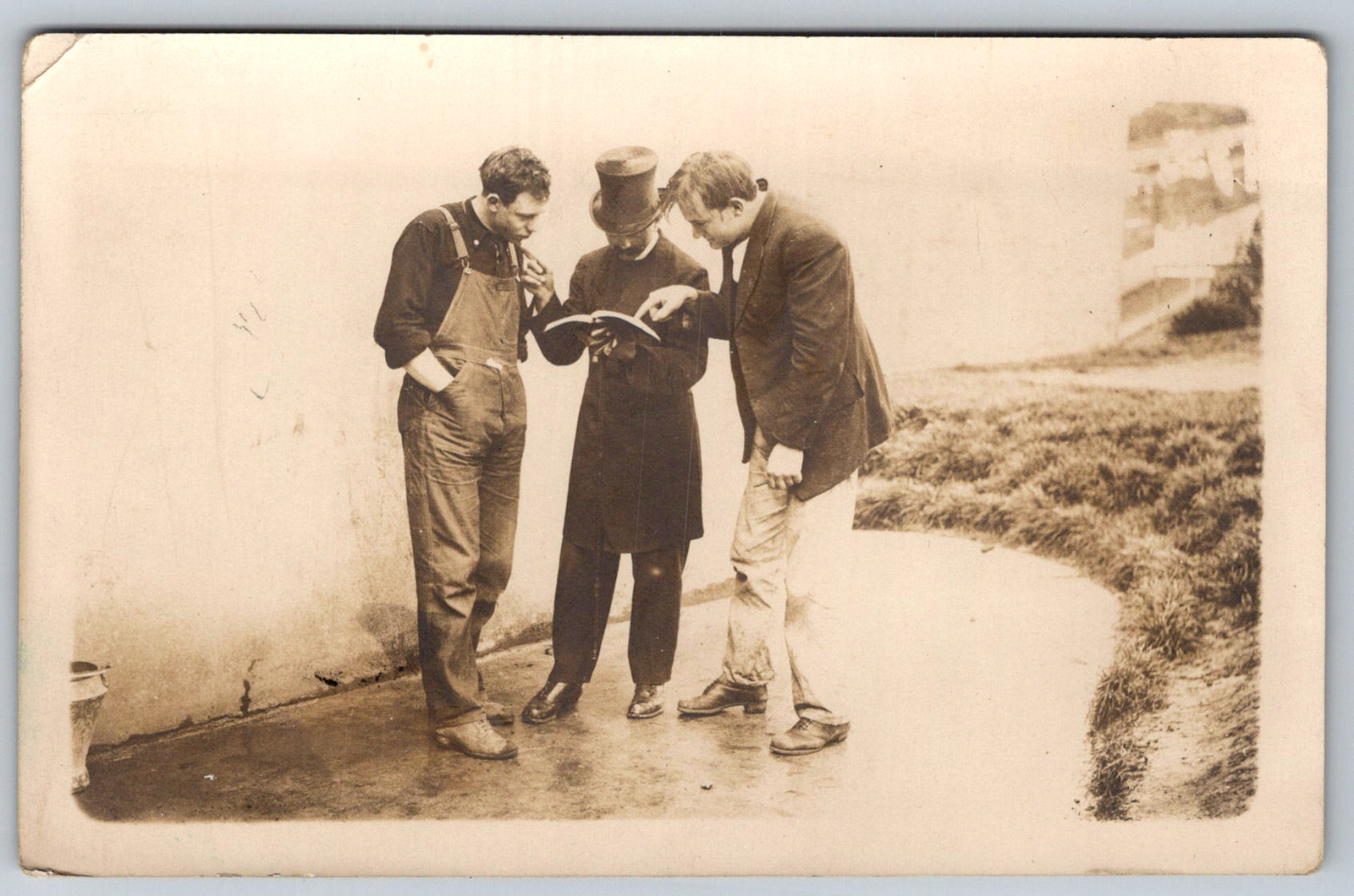 RPPC c1910s Three Men Reading Book Top Hat Workwear Scene Postcard