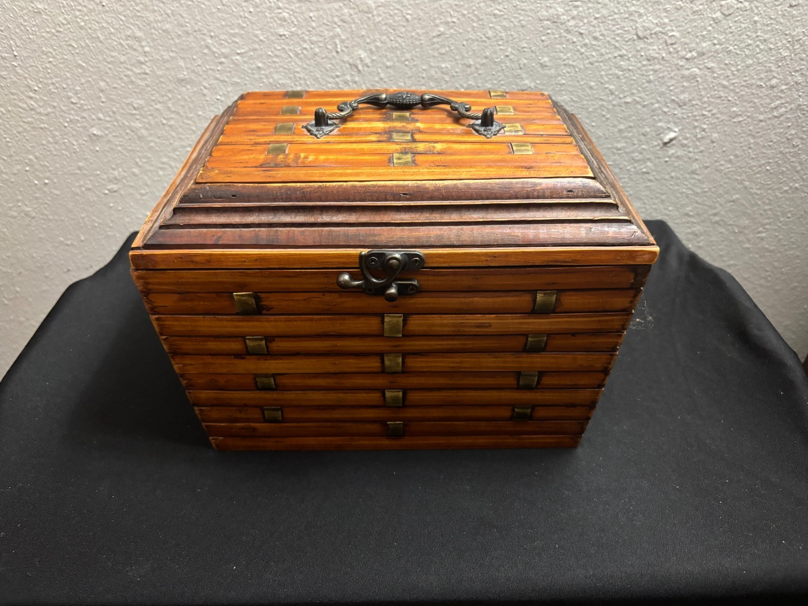 This vintage wooden box is an elegant accent to any decor. The metal handle and 
