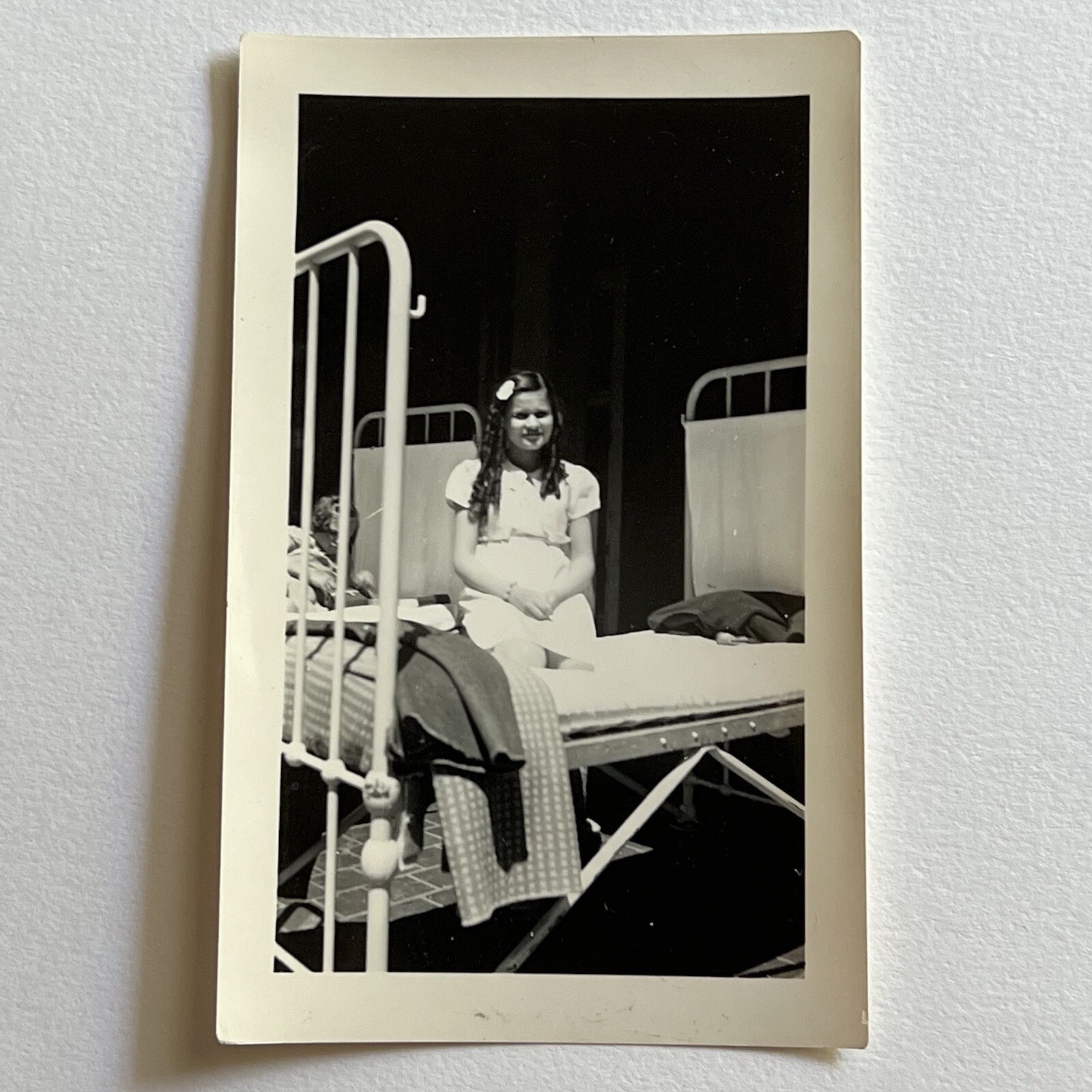 Vintage B&W Snapshot Photograph Adorable Little Girl Orphan Sitting On Bed