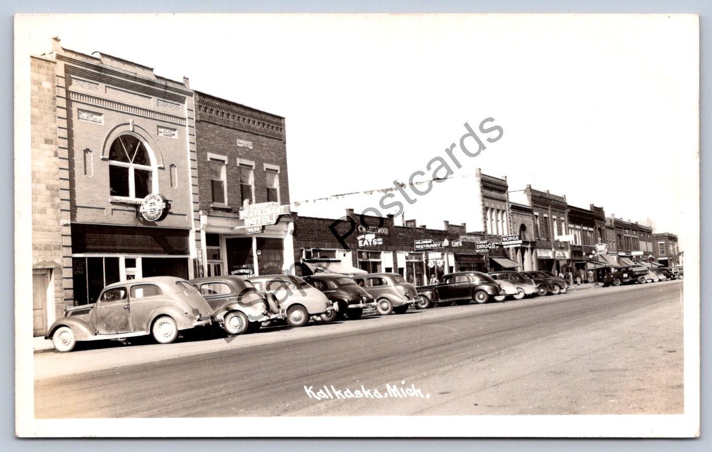 K65/ Kalkaska Michigan RPPC Postcard c1950s Main Street Stores Autos  111