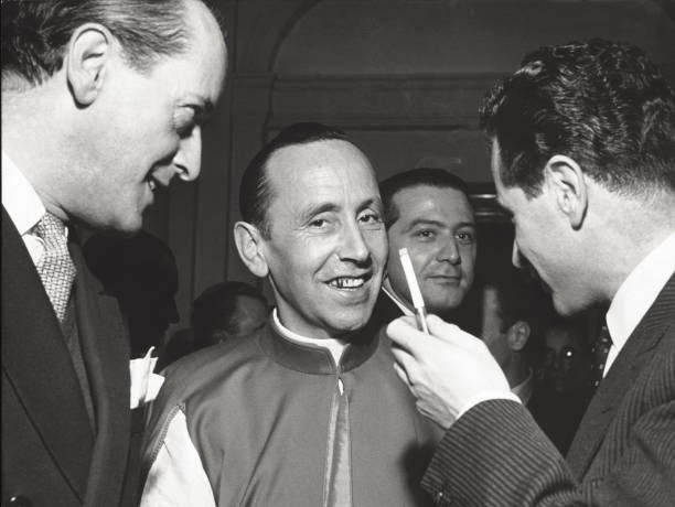 The Italian defense minister Giulio Andreotti posing behind a prel- Old Photo