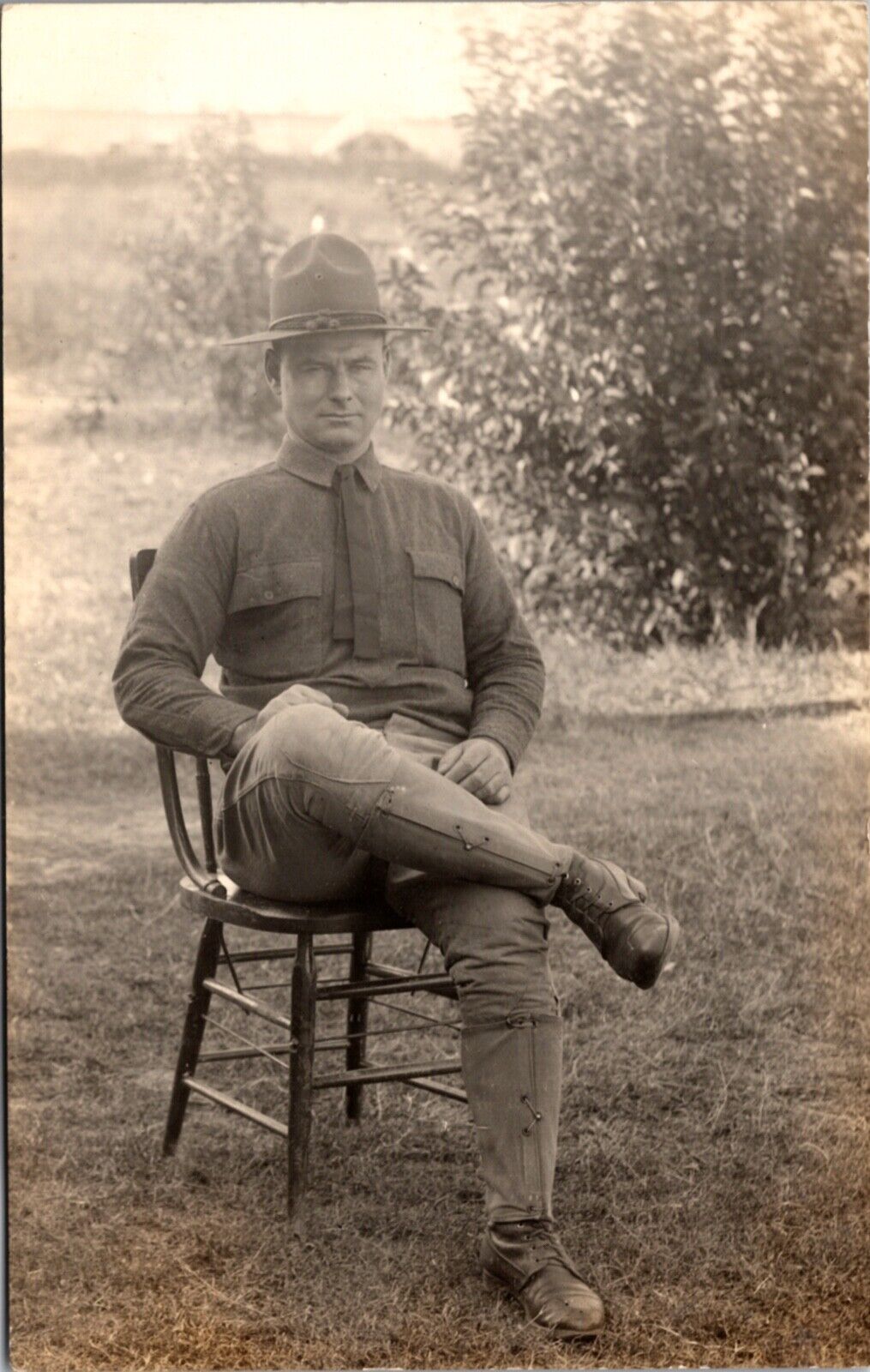 Real Photo Postcard Military Soldier Man Sitting in Chair Outside