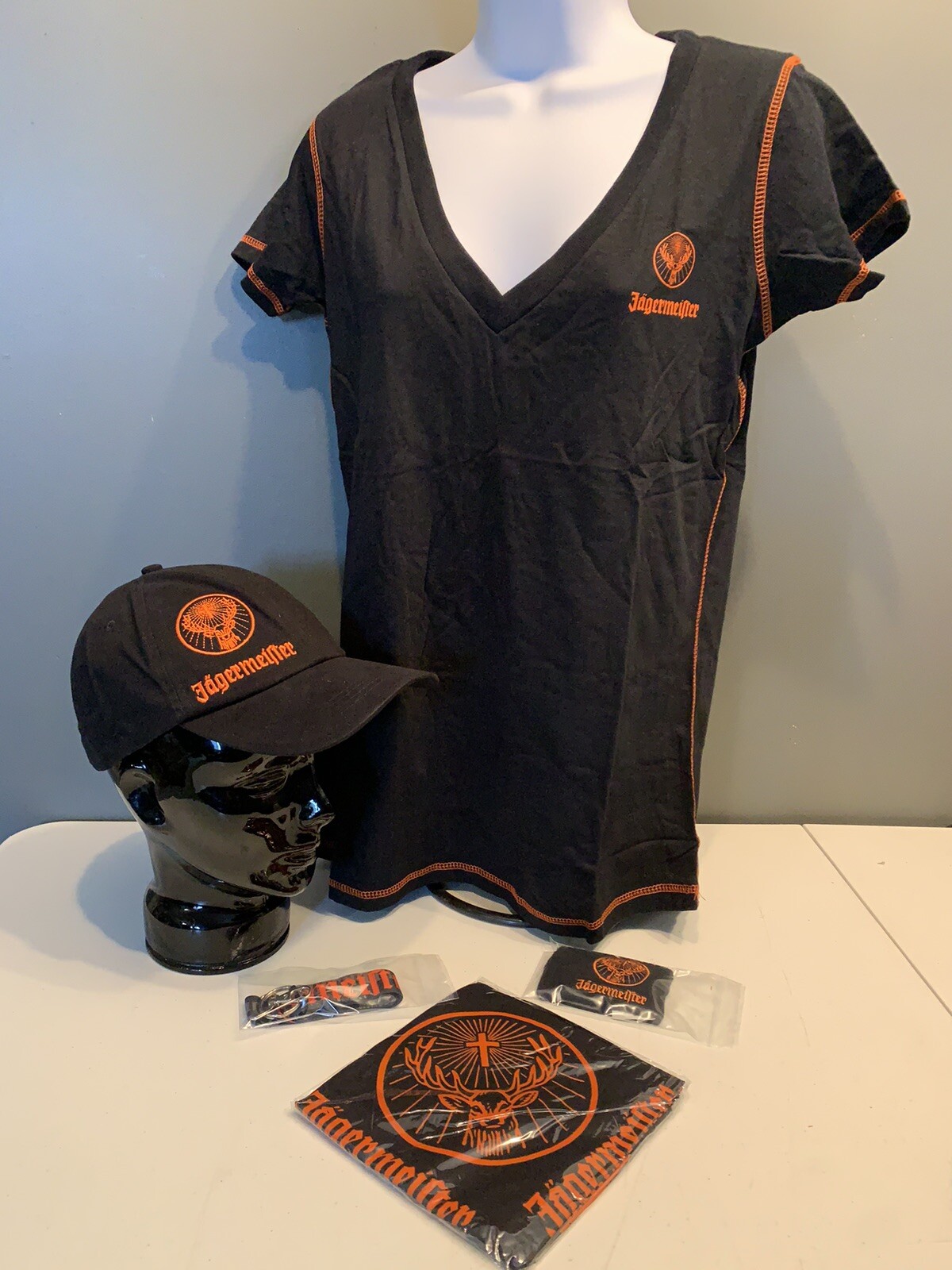 Jagermeister Women’s T-Shirt (M/L), Hat, Bandana, Lanyard, & Wrist Band.