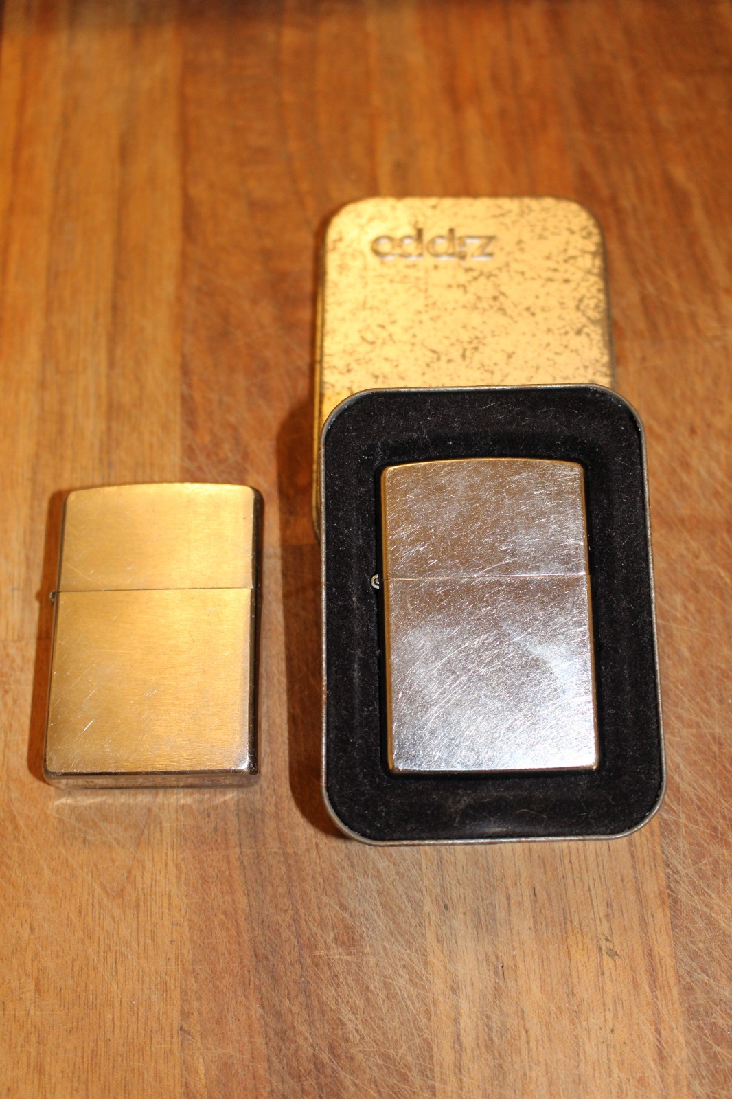 Two Zippo lighters with one case