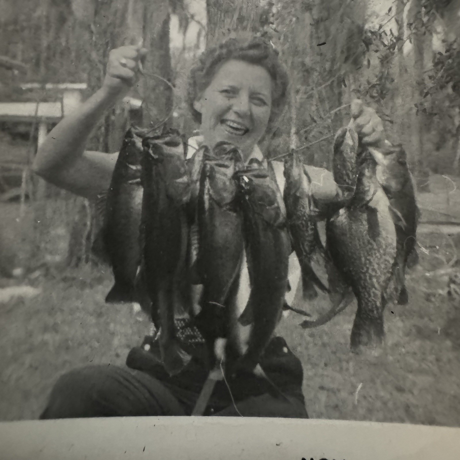 Vintage Old Candid Snapshot Photo Portrait Smiling Woman Holding String-Fish ‘56