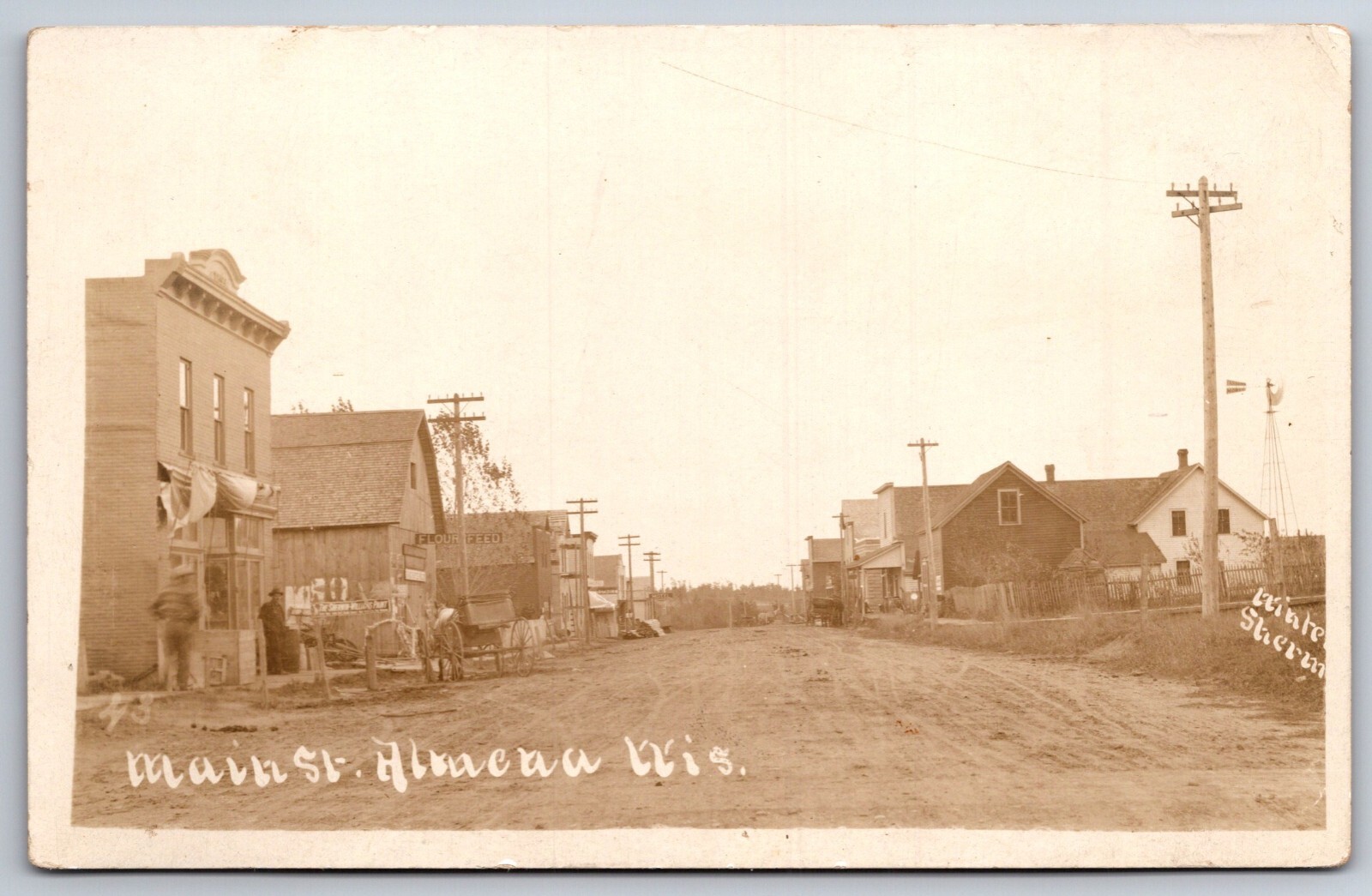 Almena WI~Main St~Flour & Feed Store~Hotel~Sherwin-Williams Paint Sign~RPPC 1916