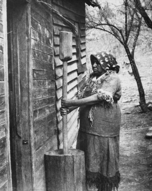 Cherokee woman of North Carolina pounds corn into mash US circa 1940 Old Photo