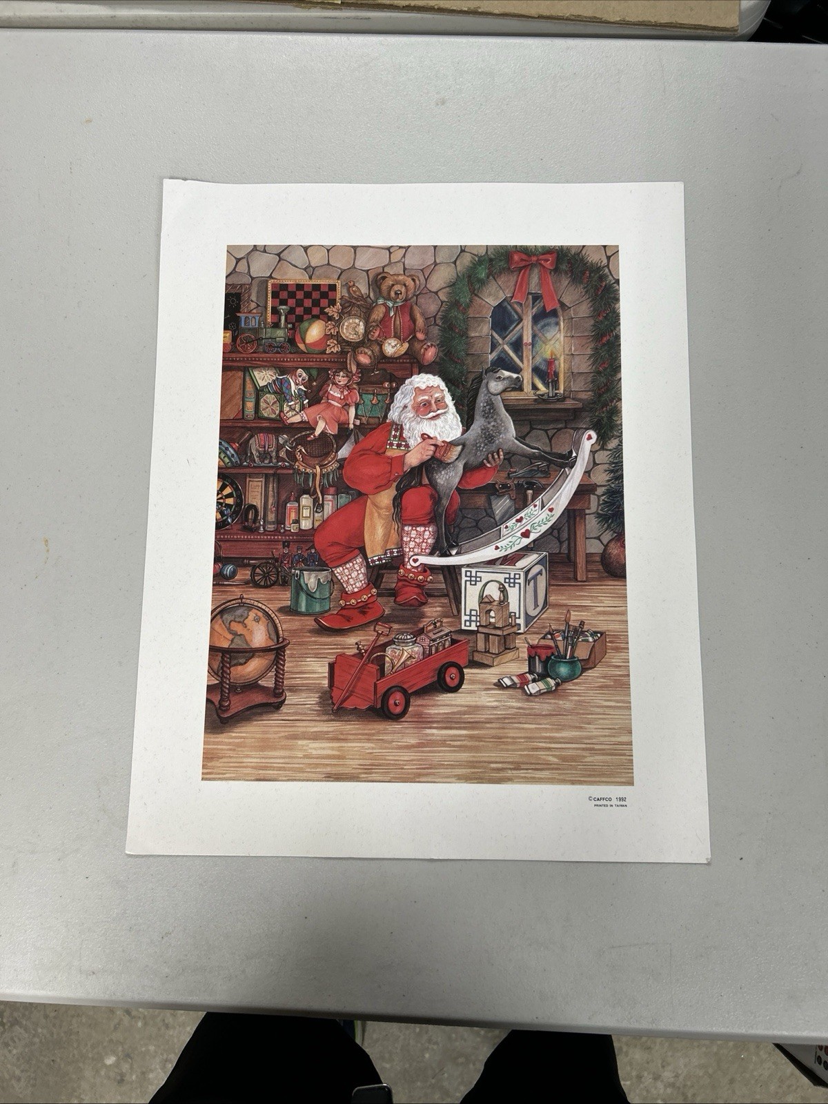 vintage 1992 Caffco Christmas art print featuring Santa Claus in his workshop 