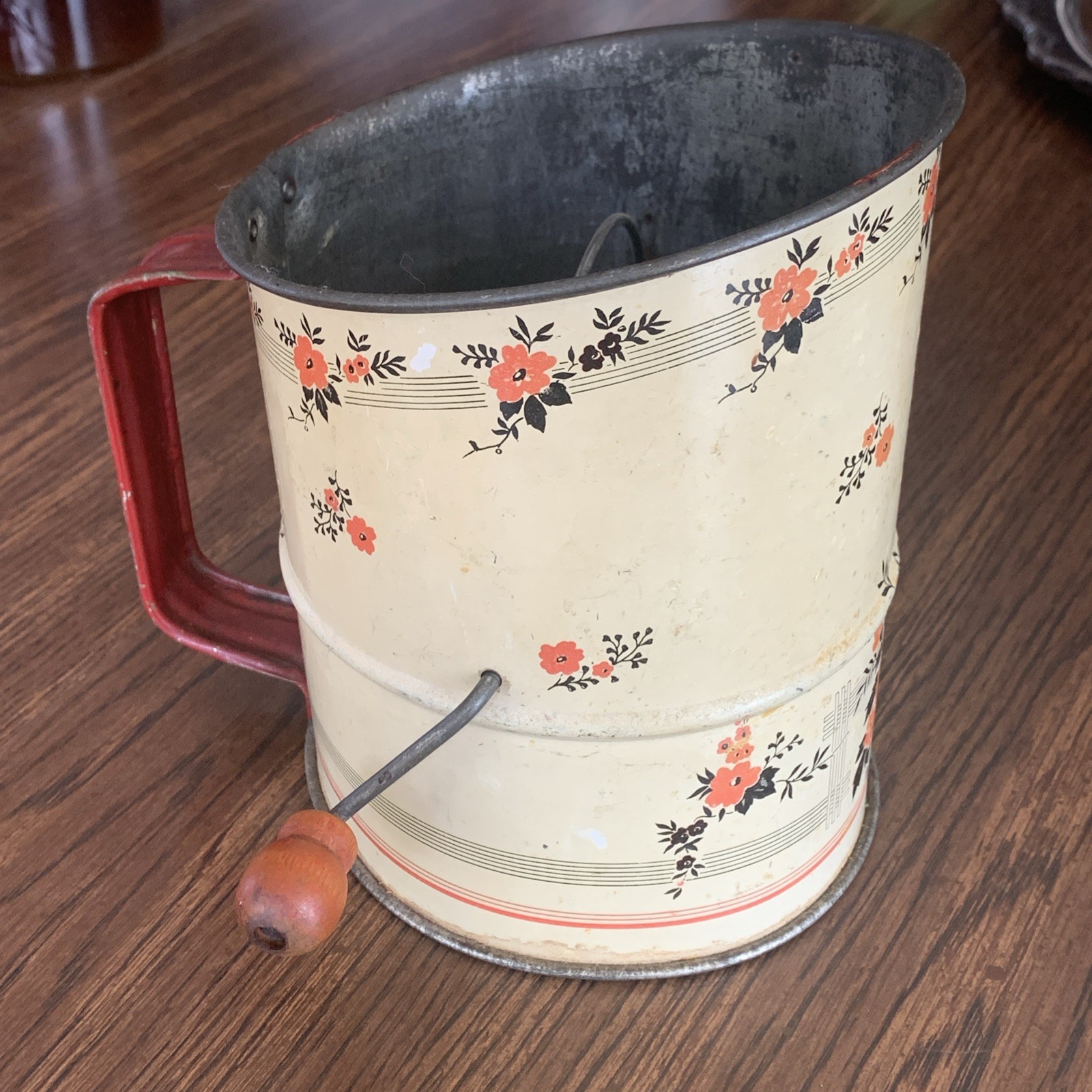Vintage Tin Flour Sifter Feat. Beige Body And A Red Flower Design Vintage Tin Flour Sifter Feat. Beige Body And A Red Flower Design