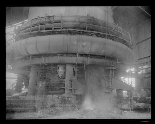 A worker standing next to pipes at Newcastle Steelworks, NSW, 16 J - Old Photo