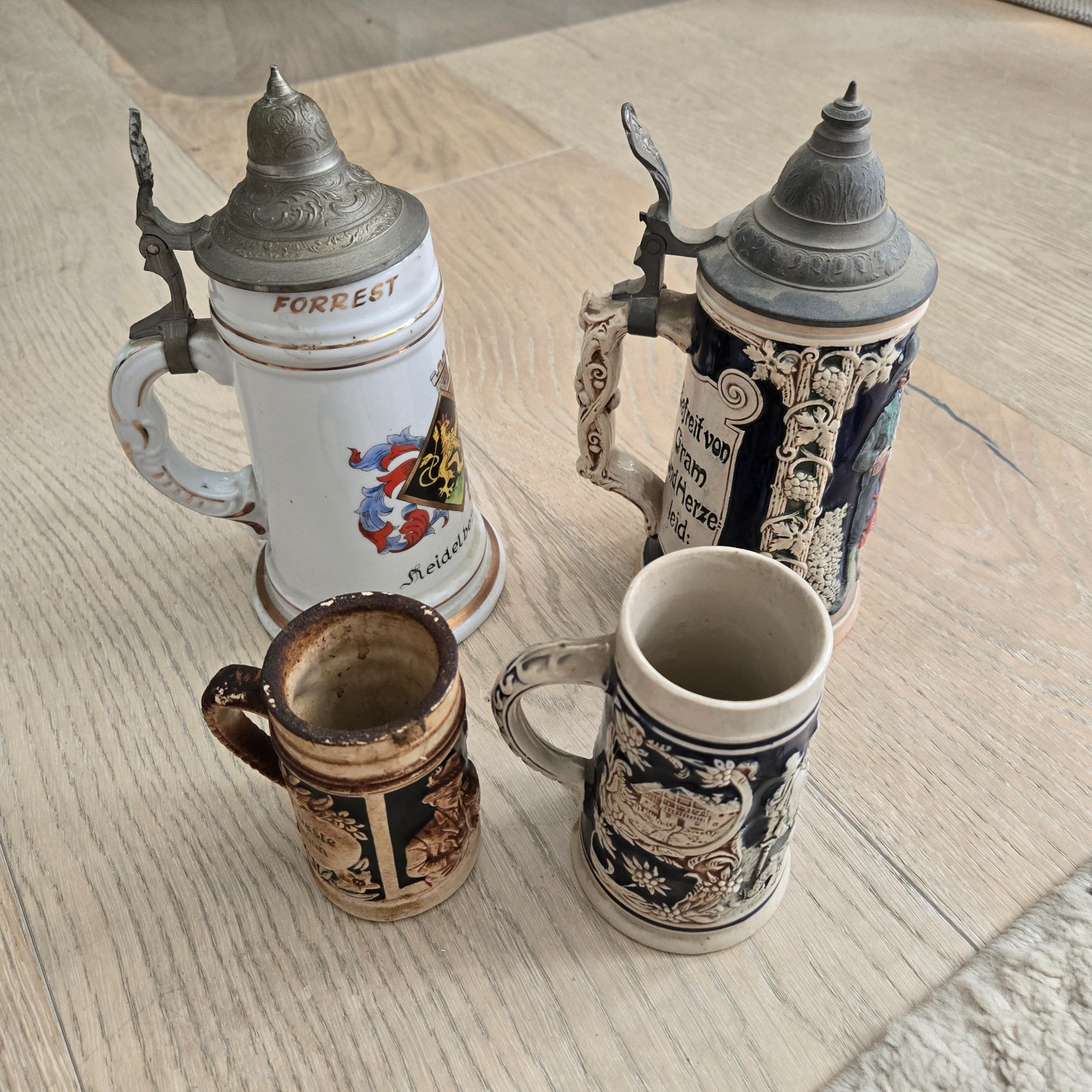 AN AWESOME, (LOT OF 4) GERMAN BEER STEINS. 5”-10”TALL
