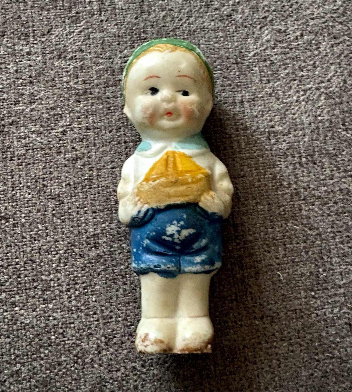Vintage 1930s bisque porcelain Frozen Charlie penny doll holding sailboat
