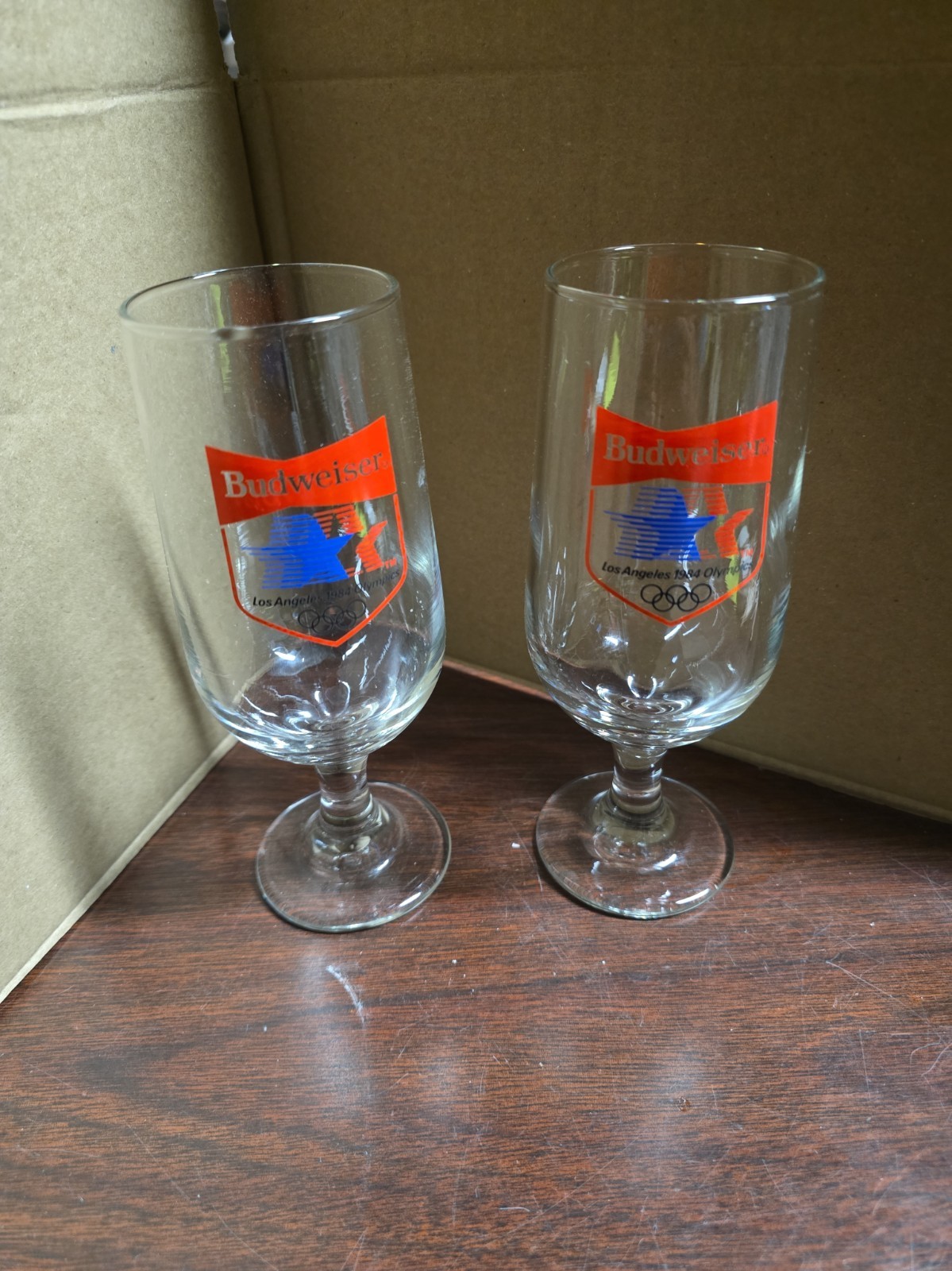 MINT PAIR OF VINTAGE 1984 BUDWEISER LA OLYMPICS STEMMED BEER GLASSES