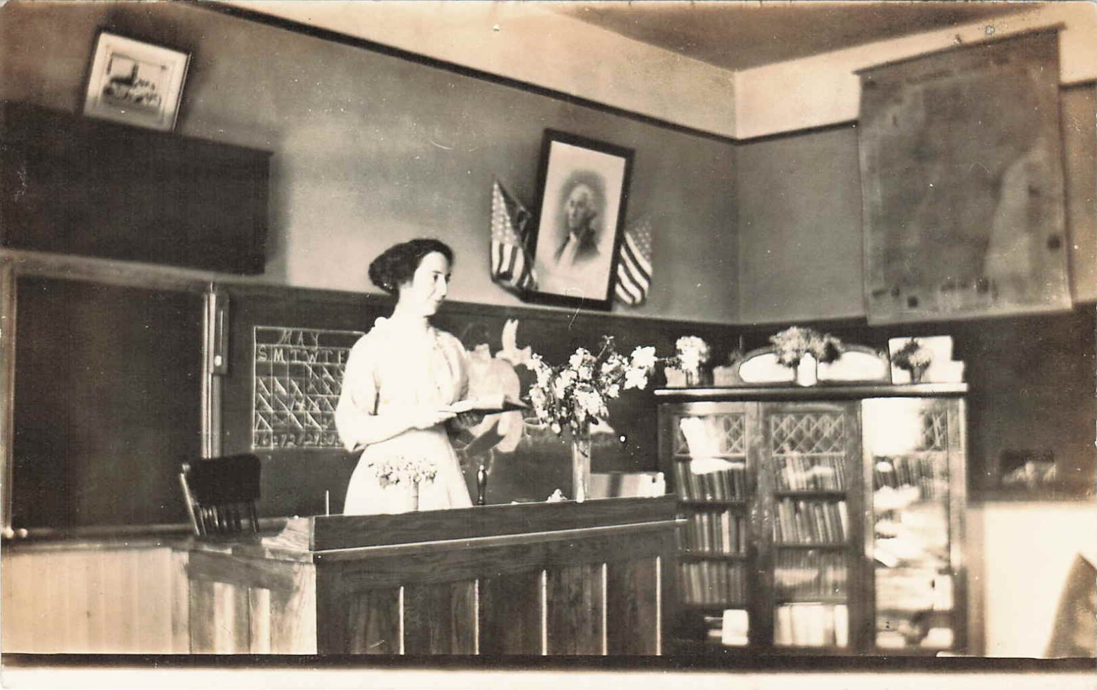 RPPC Postcard Classroom and Teacher With Book Adolph Neuman 1912 American Flags