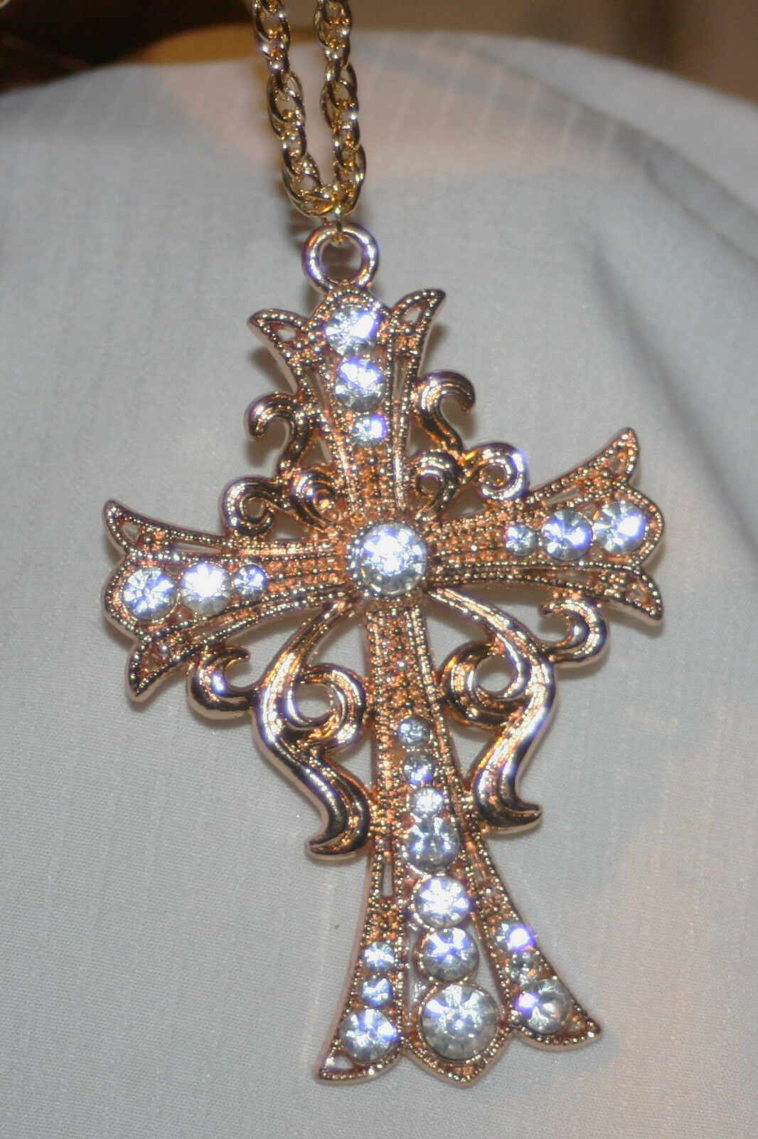 Striking Goldtone Tendril Swirled Sparkling Rhinestones Cross Pendant Necklace