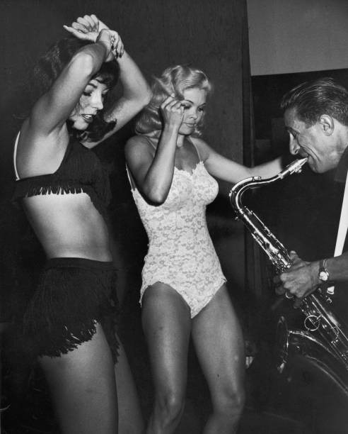 Scantily clad Joan Collins given lessons art striptease by Gypsy R- Old Photo