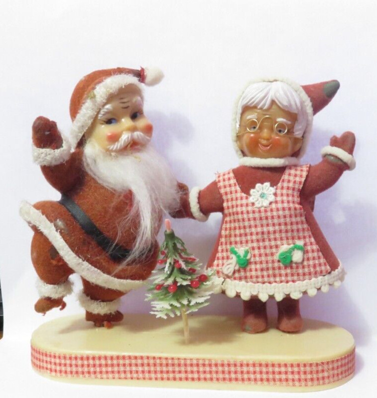 VINTAGE FELT AND PLASTIC SANTA AND MRS CLAUSE ON STAND FADED AND WORN