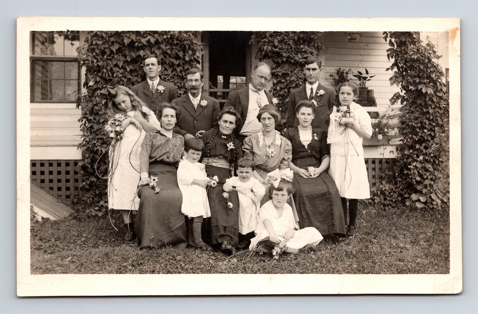 RPPC Family Portrait Men Women Girls Flowers Great Expressions Postcard