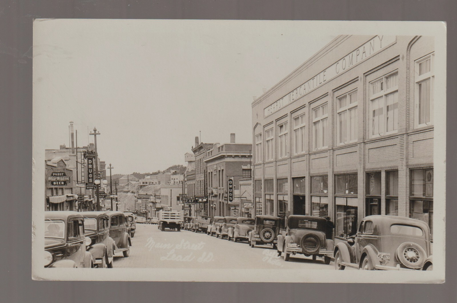 Lead SOUTH DAKOTA RPPC c1930s MAIN STREET STORES nr Deadwood BLACK HILLS SD B1