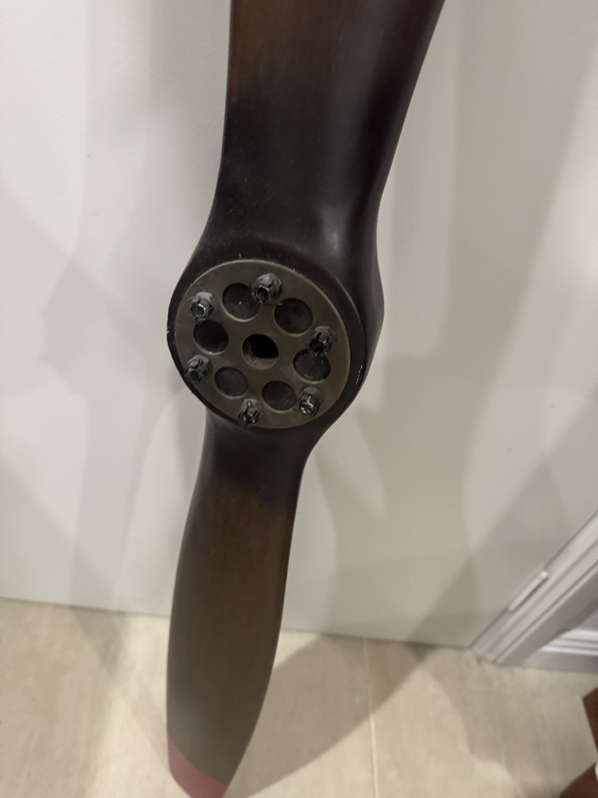 WWI-style  propeller -dark stained wood, red tips, black hub with bolt plates