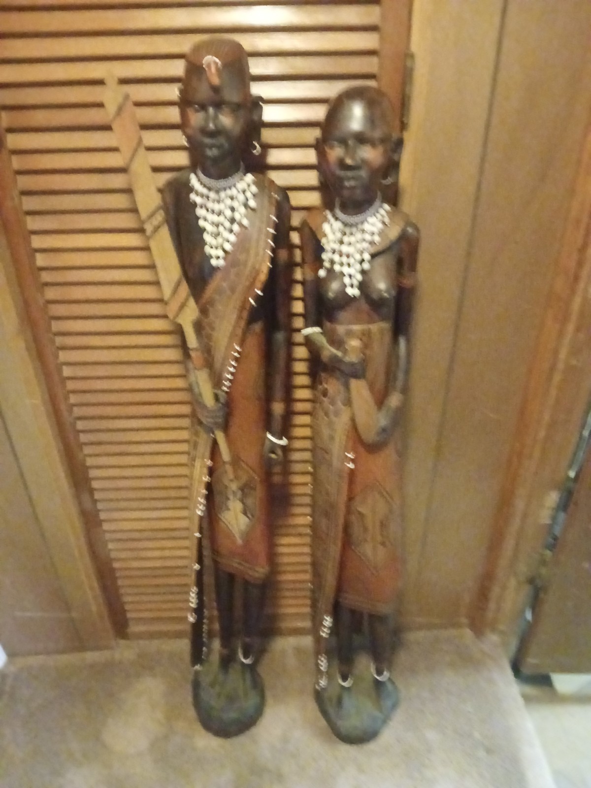 HAND CARVED 4FT. TALL WOODEN AFRICAN STATUES.