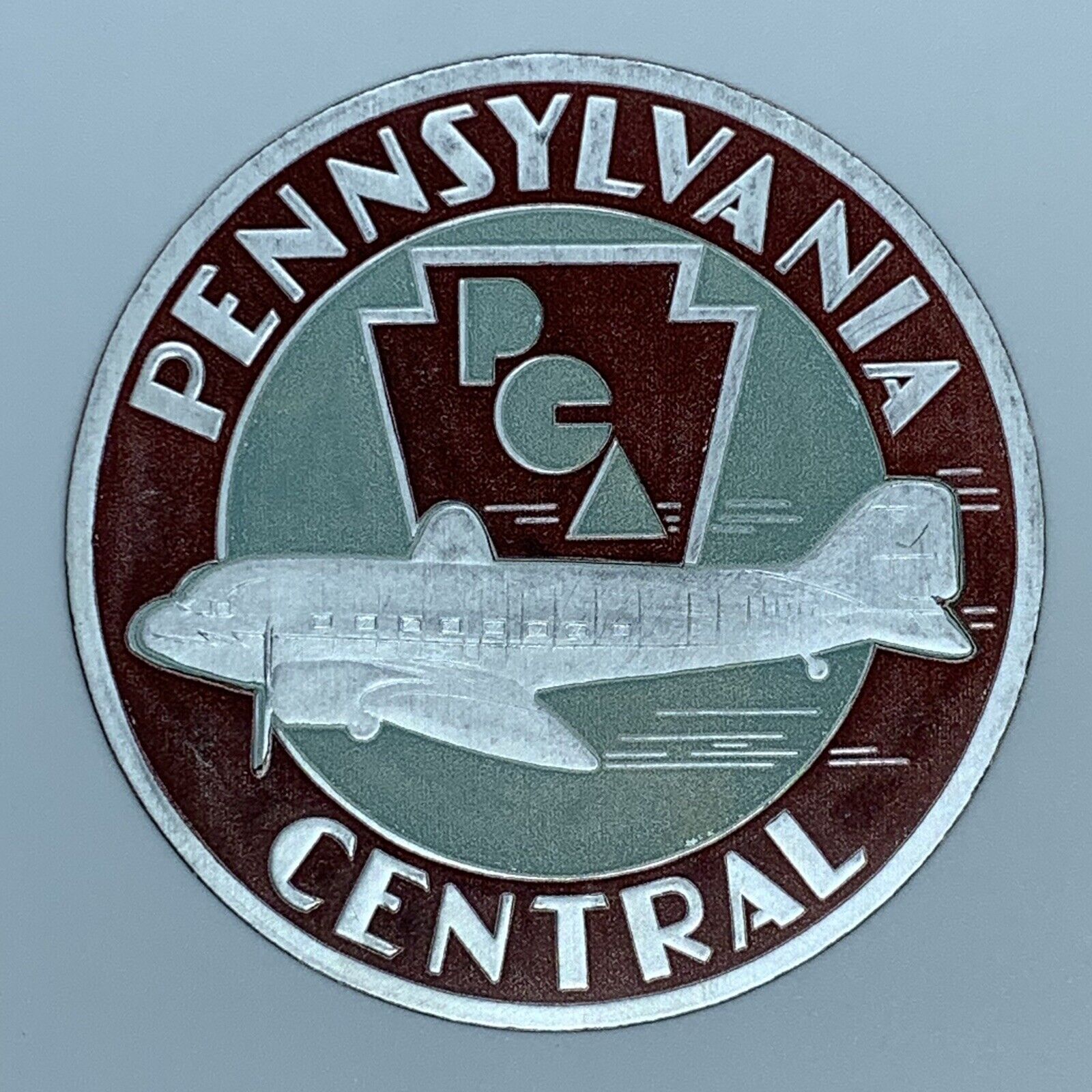 PENNSYLVANIA CENTRAL AIRLINES PCA ROUND DECAL ADHESIVE LABEL MAROON SILVER