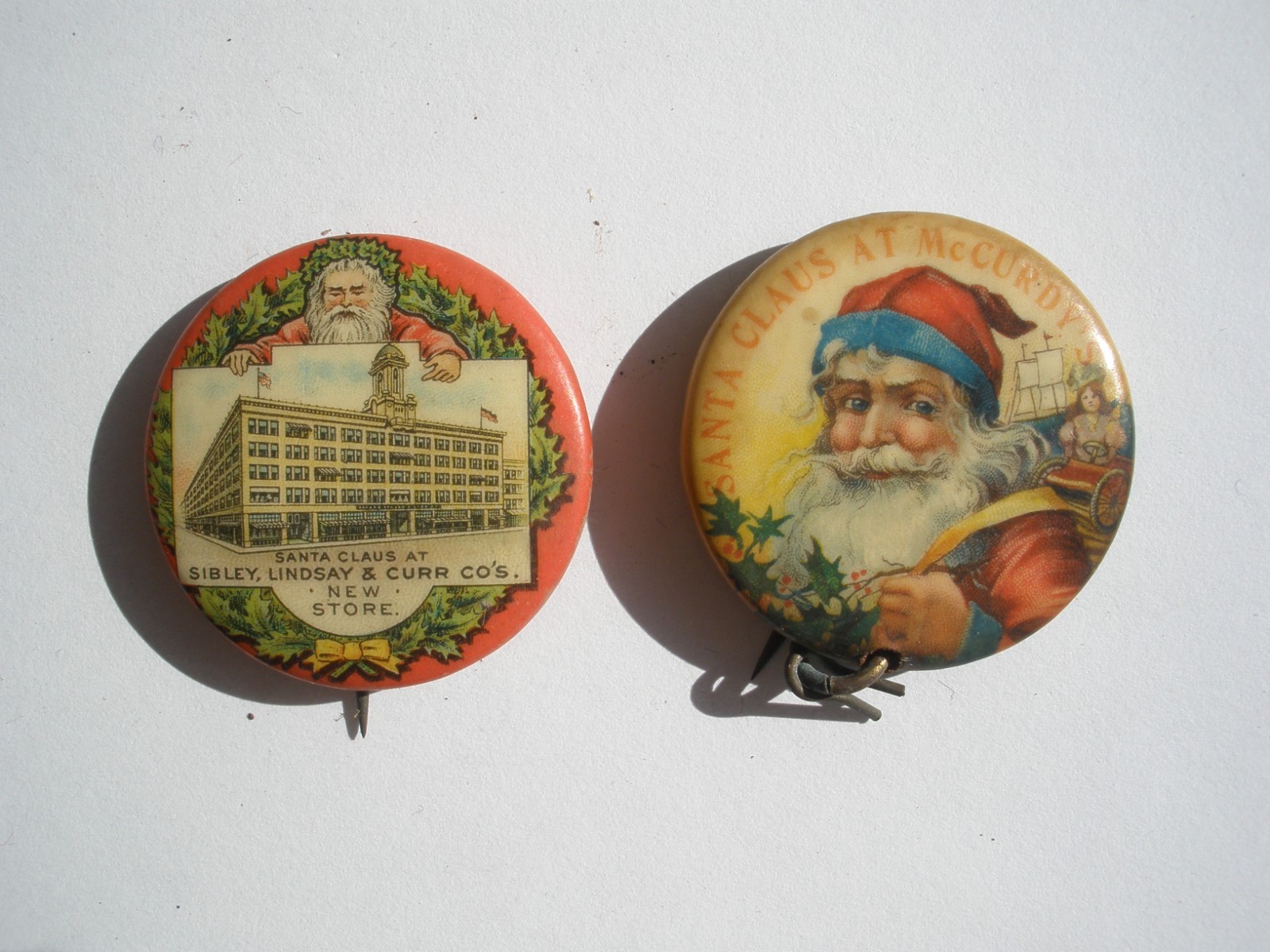 2 VTG Santa Christmas McCurdy’s & Sibley's Dept Store Celluloid Pinback button