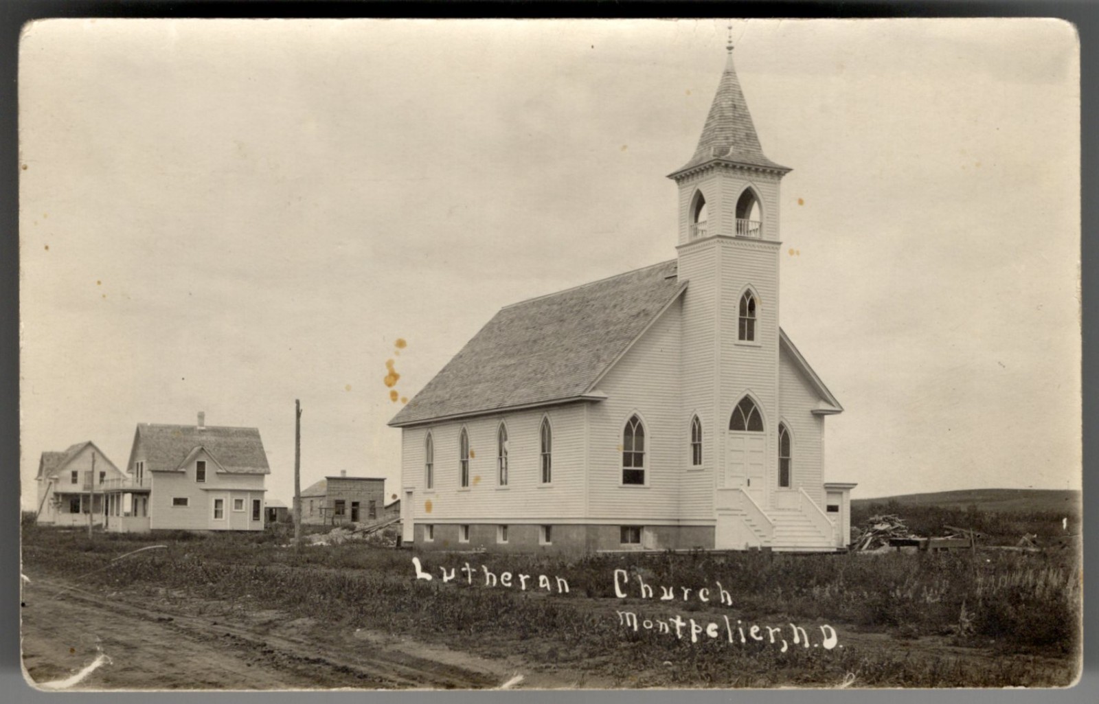 USA MONTPELIER ND 1910s Street View Lutheran Church. Real Photo Postcard