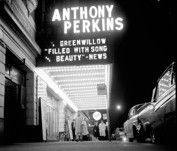 Nighttime view of dancer actor Grover Dale as he walks under a the- Old Photo