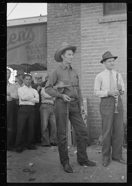 Phoenix Arizona 1940s orchestra member tuning violin outside grocery store