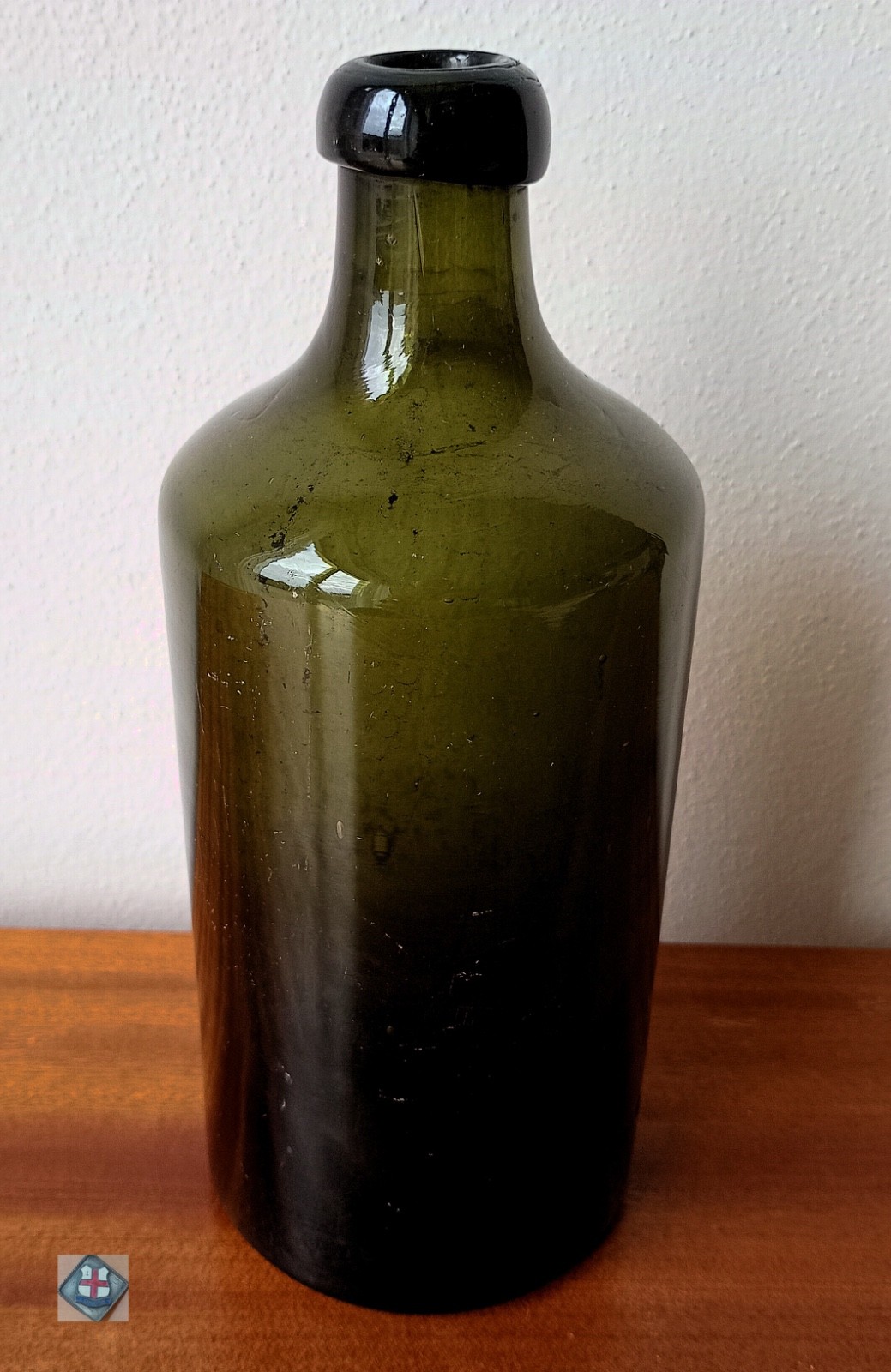 Antique bottle made of dark olive green glass (England, around 1850)