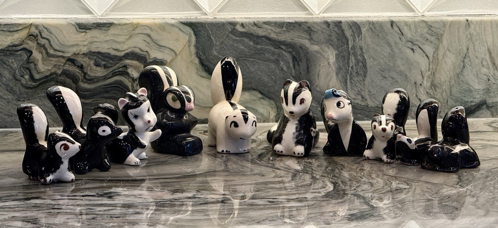 Vintage Collection of 10 Skunk Figurines One Marked Japan One Salt Shaker