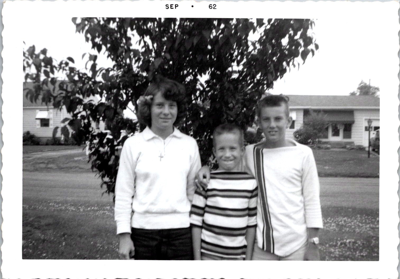 Three Smiling Siblings in Front Yard, 1962 Suburban B&W Snapshot Photo Three Smiling Siblings in Front Yard, 1962 Suburban B&W Snapshot Photo