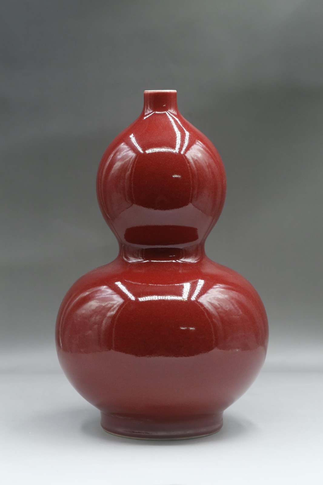 A Red-Glazed Gourd Vase A Red-Glazed Gourd Vase
