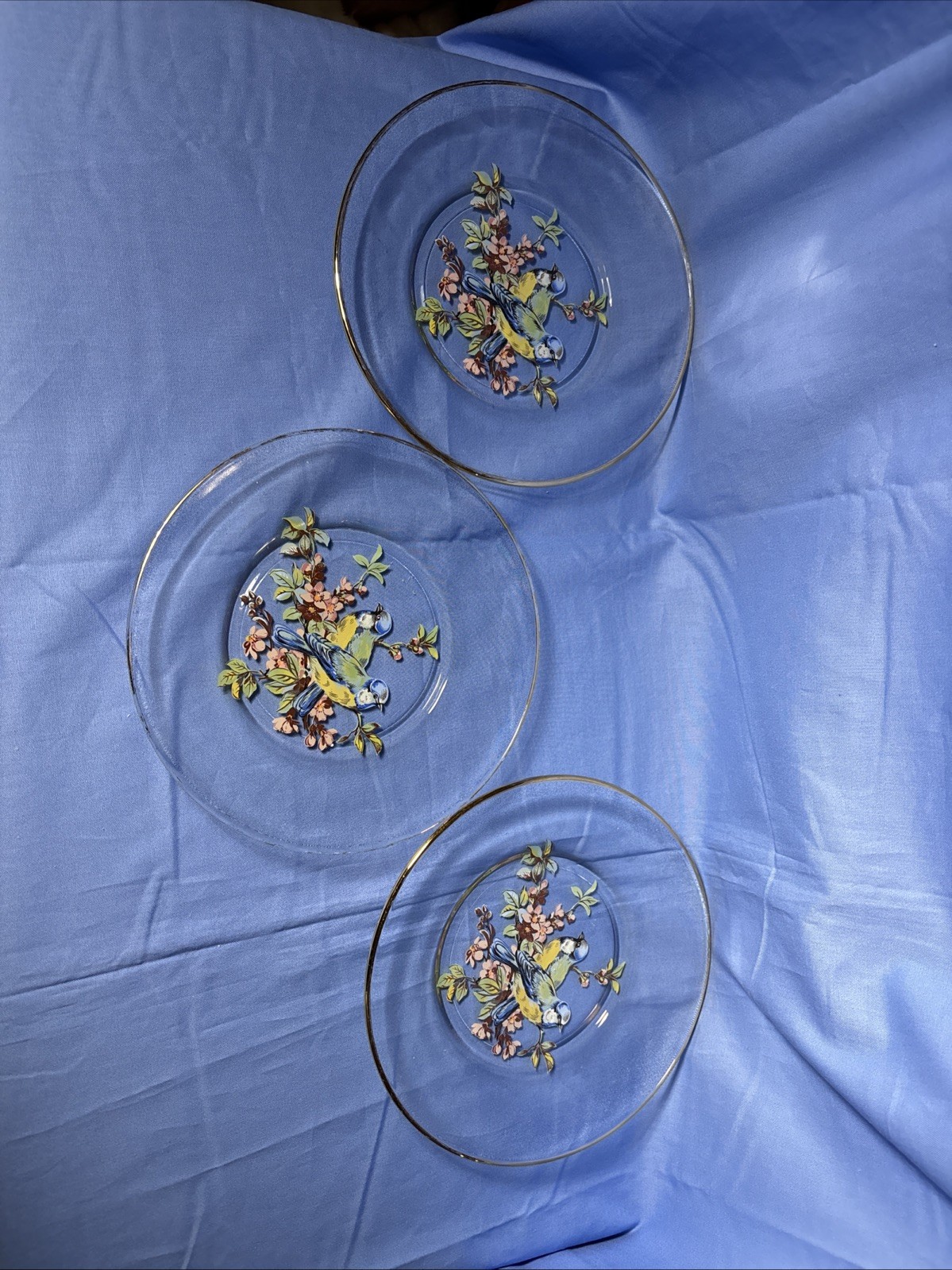 Set Of Three Clear Glass Gold-Rimmed Plates Featuring A Bluebird