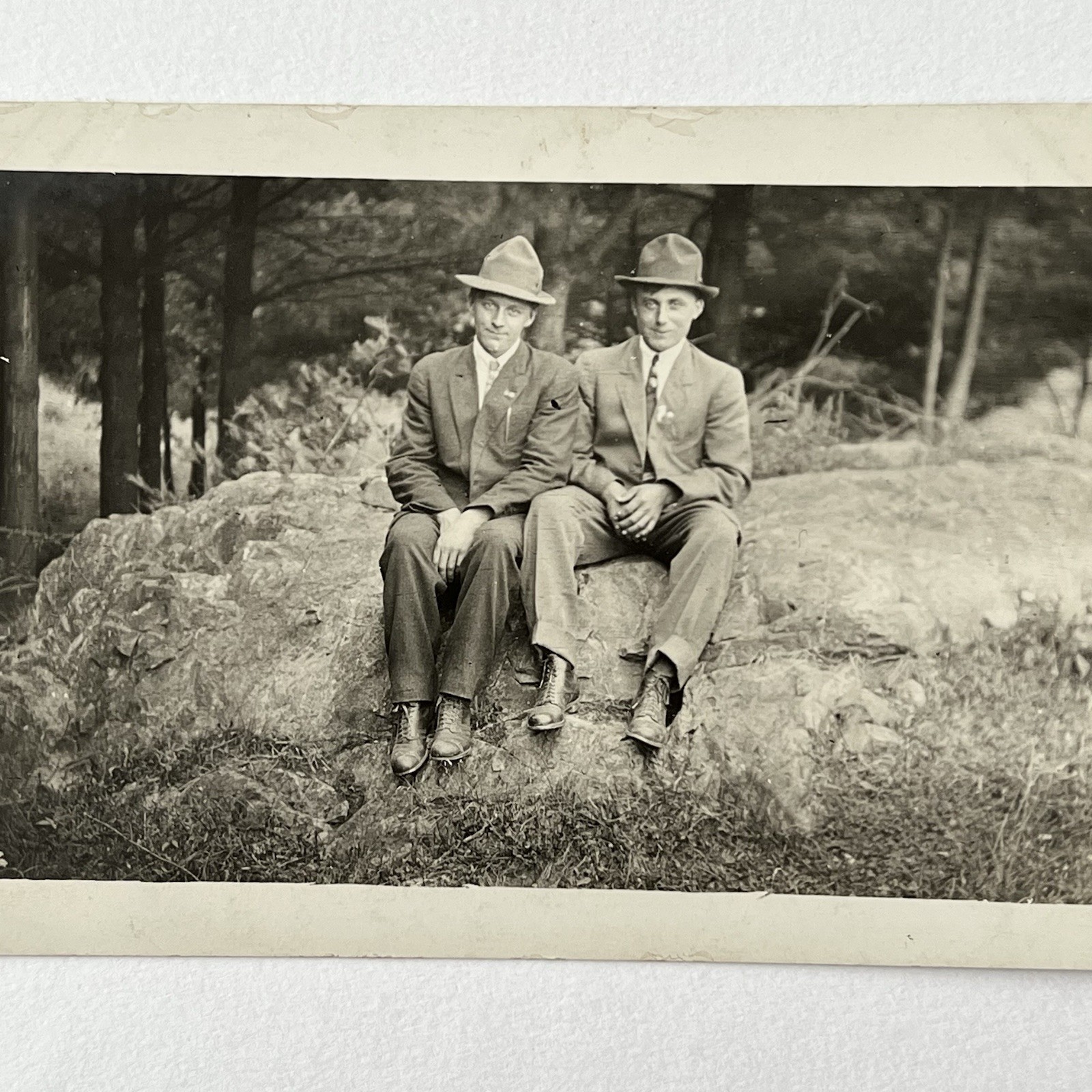 Antique RPPC Photograph Postcard Handsome Young Men Sitting On Rock Hat Brothers